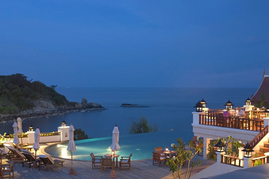 The outdoor swimming pool with loungers alongside