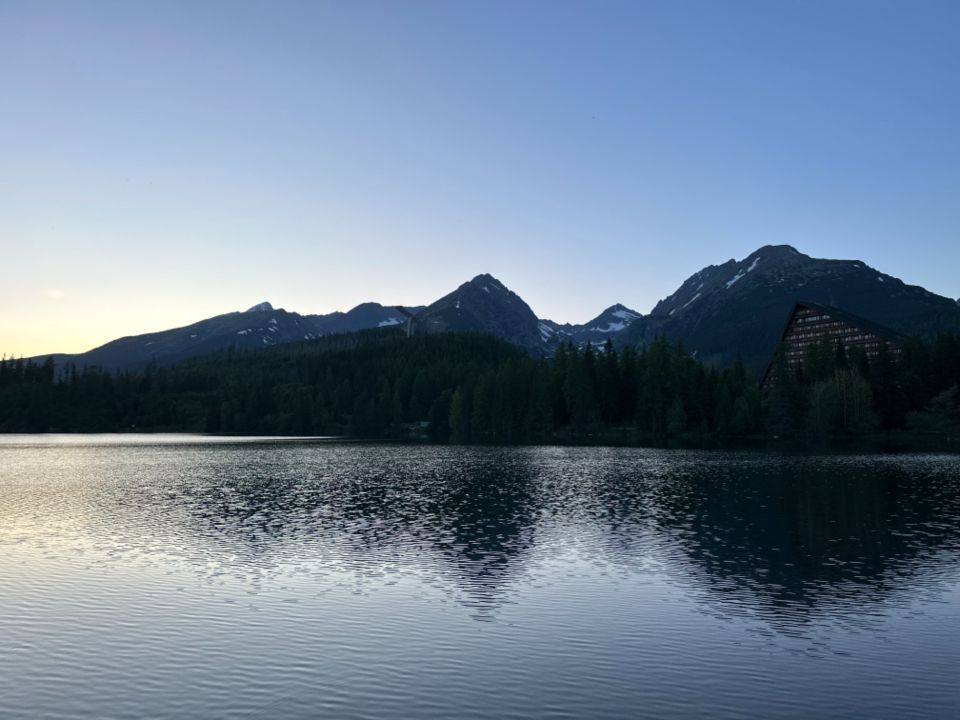 The lake, still, with hills behind