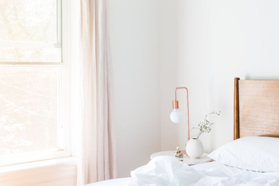 A guest room with a large bed and soft lighting